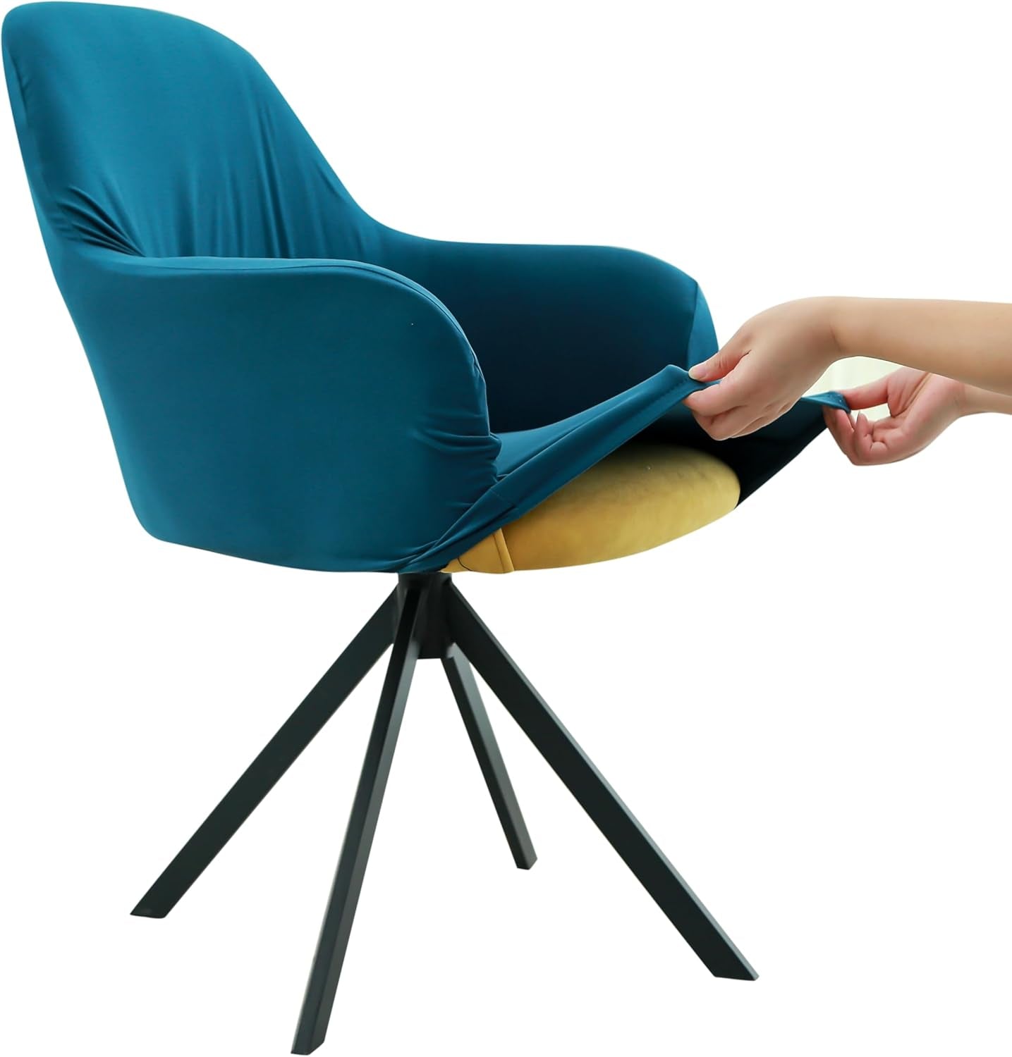 Hand pulling a teal stretch slipcover over a mid-back armchair to show elastic fit.