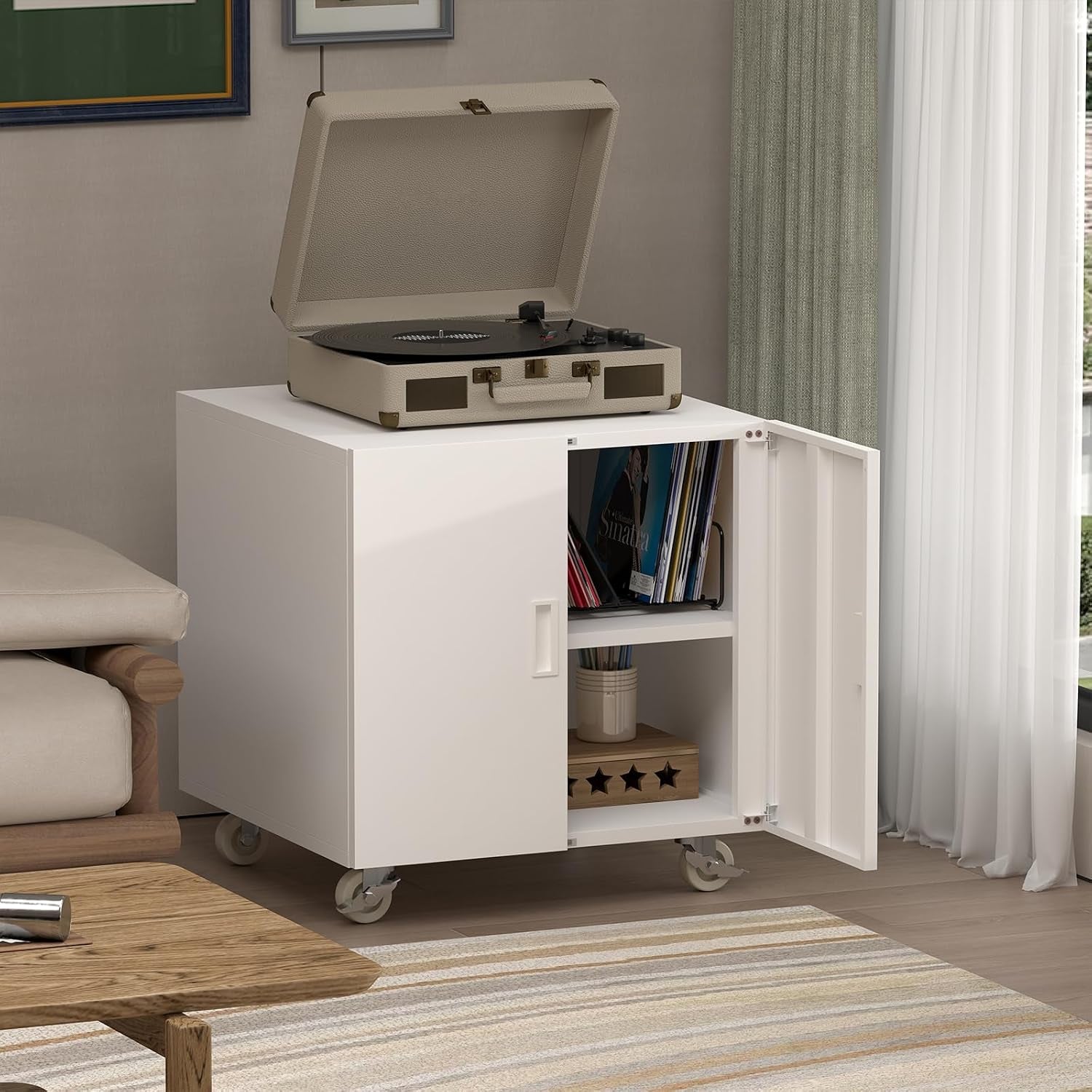 Living-room styled white cabinet on wheels with its door open, a record player on top and vinyls visible inside