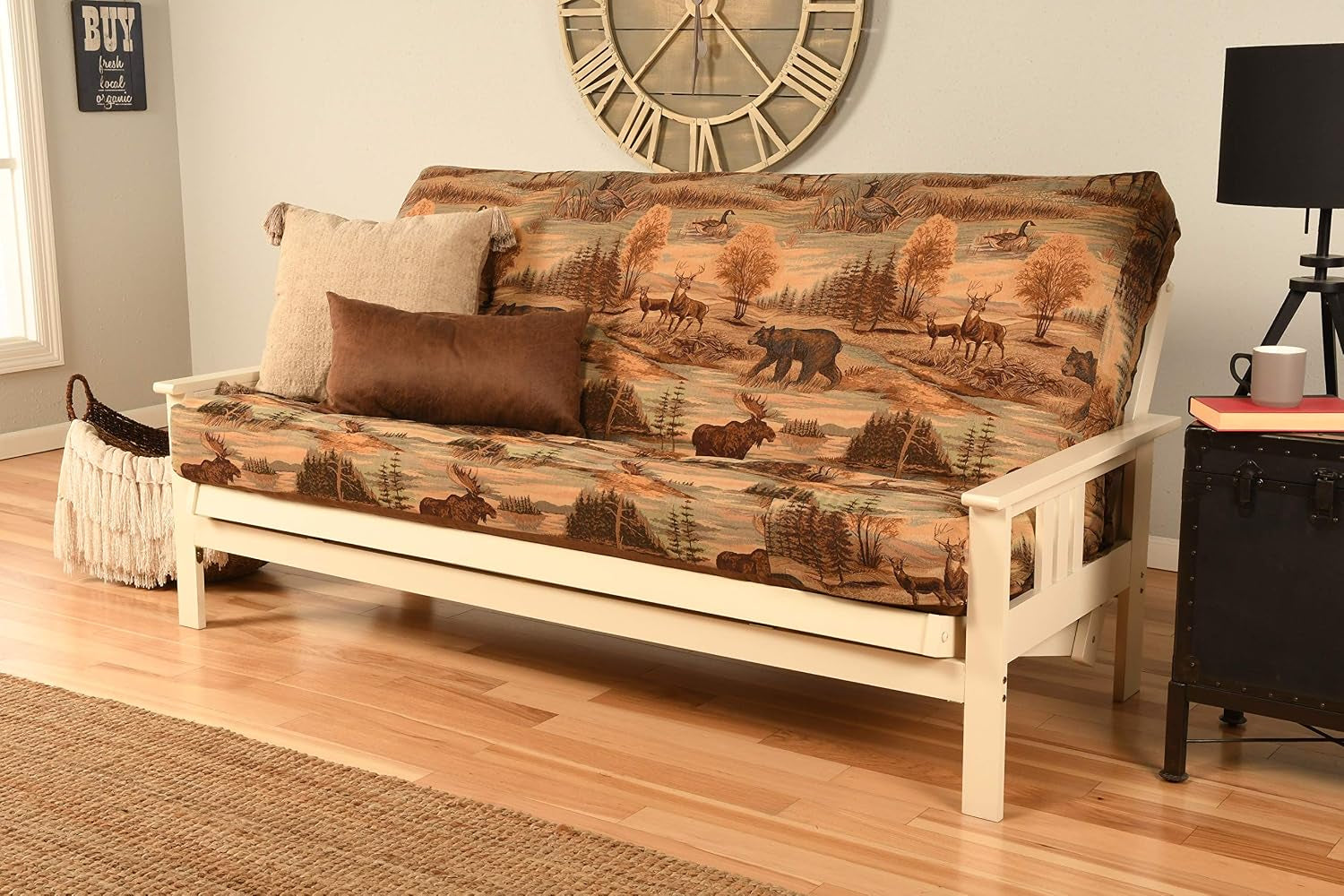 Patterned outdoors fabric futon on a cream-painted hardwood frame, shown with textured rug