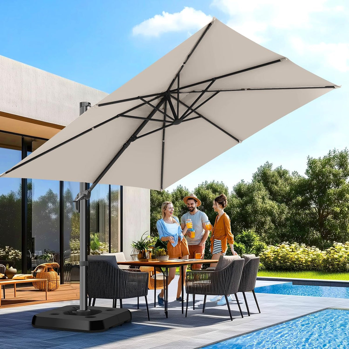 Beige cantilever umbrella angled over an outdoor dining table on a poolside patio with three people nearby