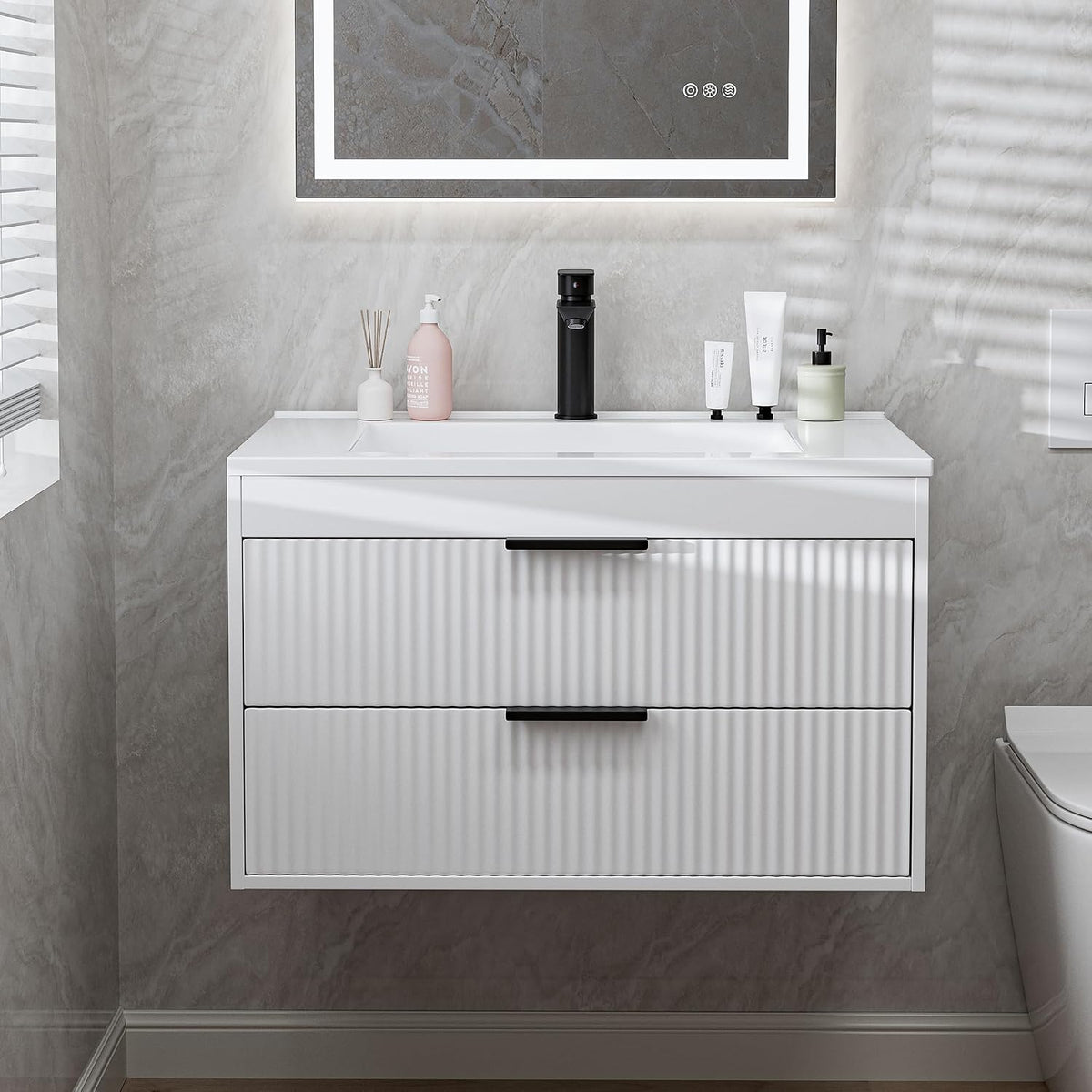 Front view of a floating white vanity with integrated white sink and two closed ribbed drawer fronts.