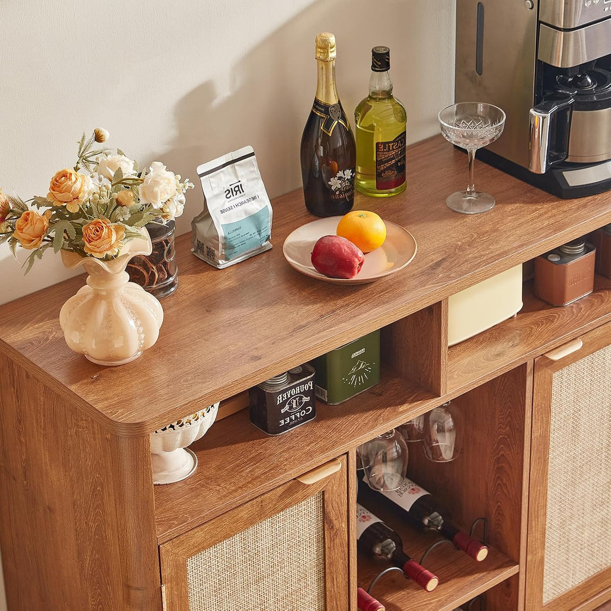 Close-up of the cabinet top and open cubbies holding decor, coffee maker and small appliances