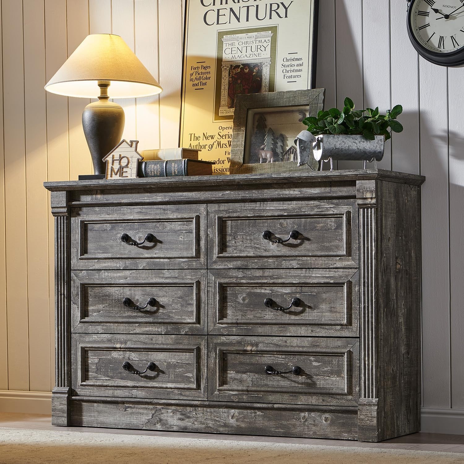 Six-drawer dresser in weathered gray wood finish with metal bail handles and fluted corner columns.