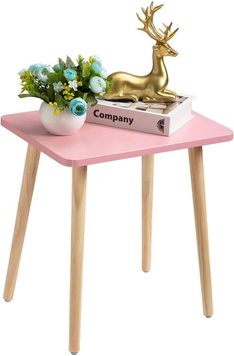 Single small pink square side table with natural tapered wood legs, shown with a vase and decorative deer figure