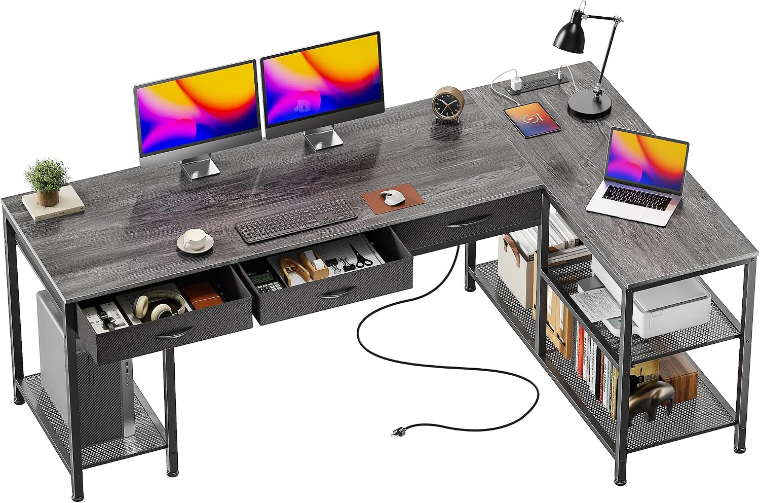 Dark gray L-shaped desk from a higher angle highlighting the roomy corner workspace and a coiled power cord on the floor.