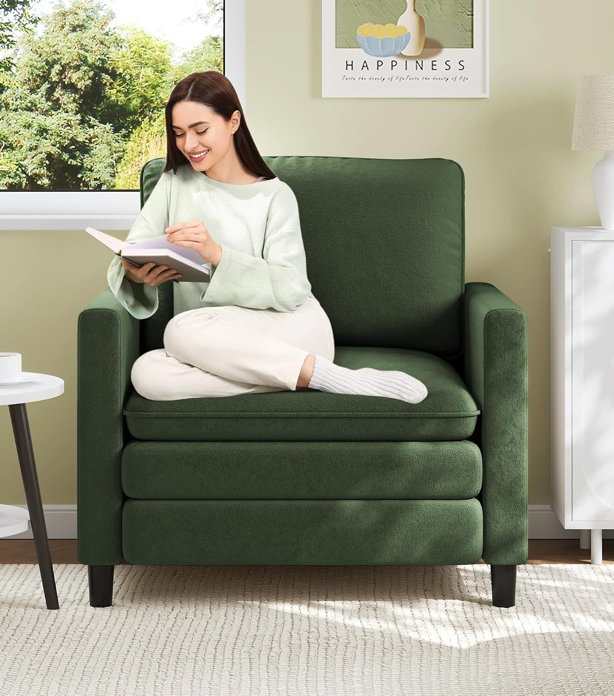 Front view of a single-seat green teddy-fabric loveseat with a woman reading on it.