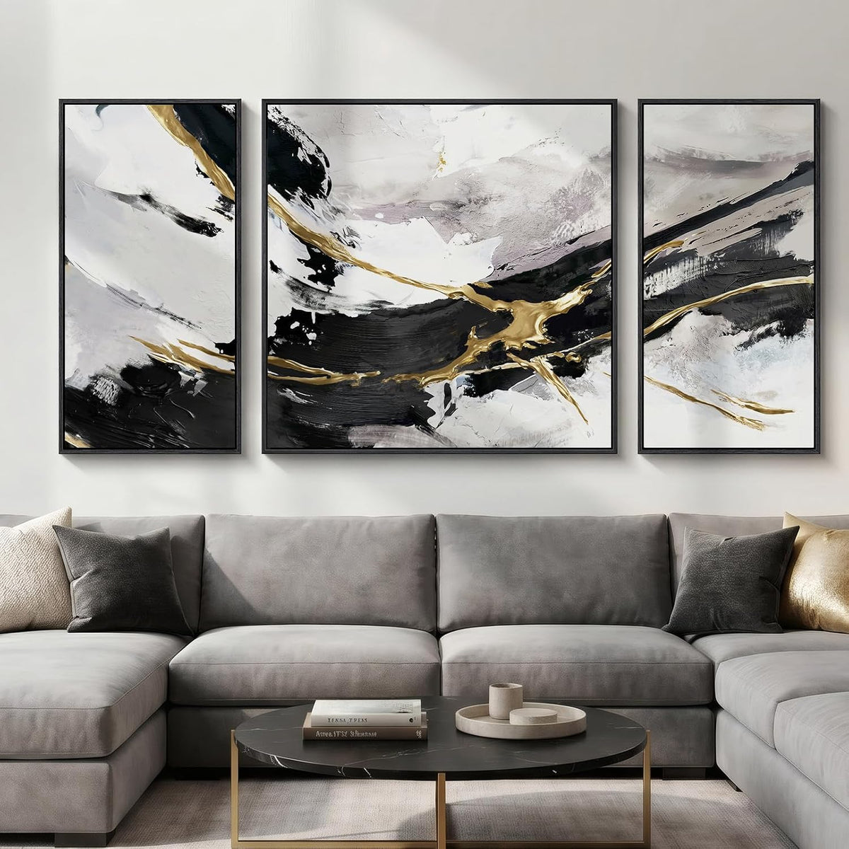 Three-panel set with a large square center and two narrow side panels above a light-gray fabric sectional and round black