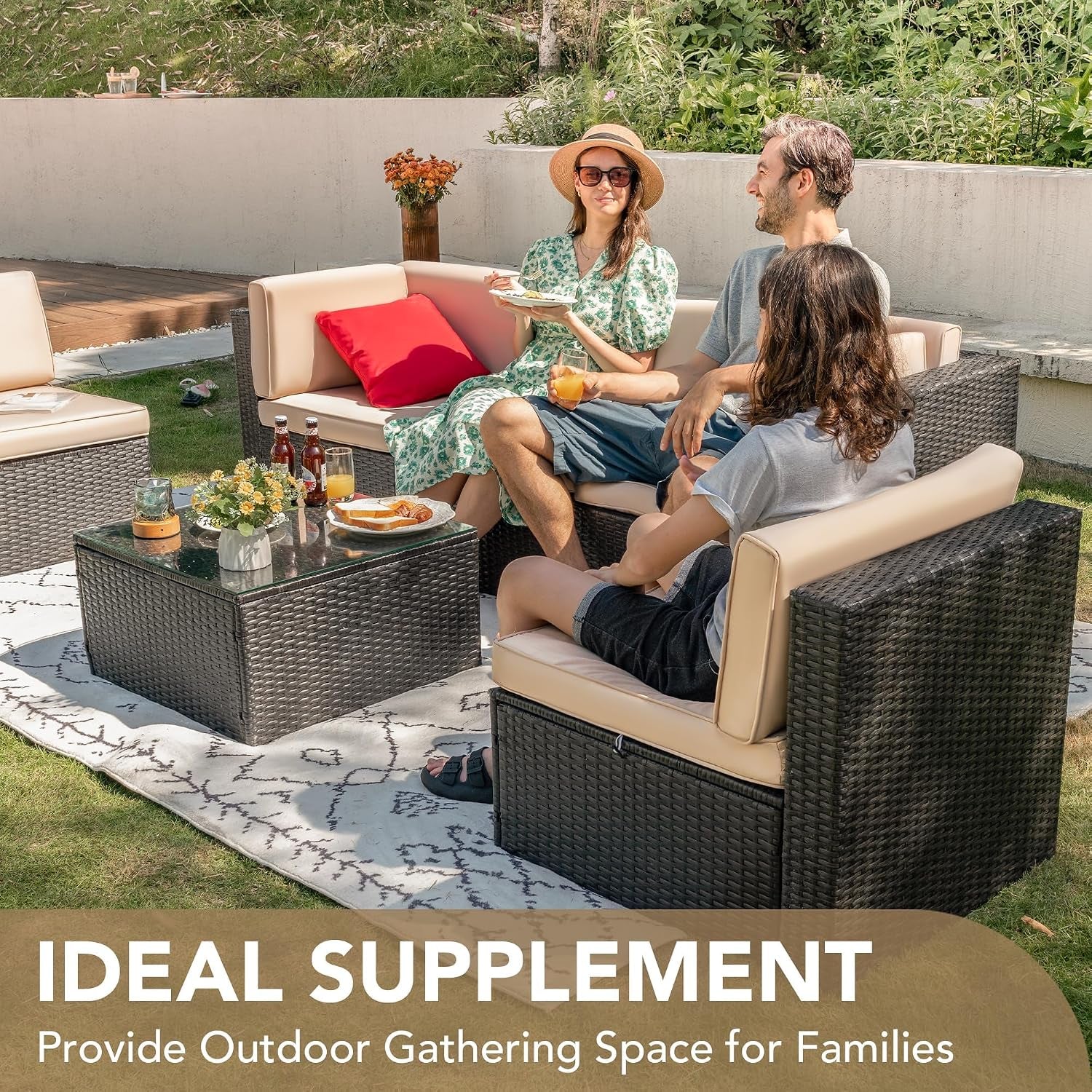 Outdoor shot of a dark wicker sectional with beige cushions and glass-top coffee table; three people seated and drinks on