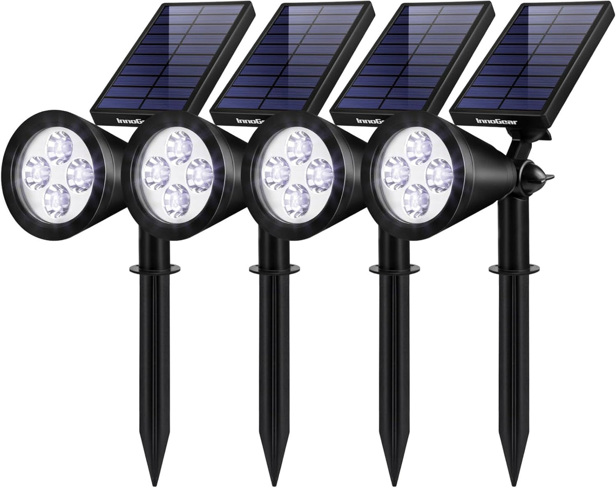 Four black solar spotlight stakes with round lamp heads and angled solar panels shown on white background.