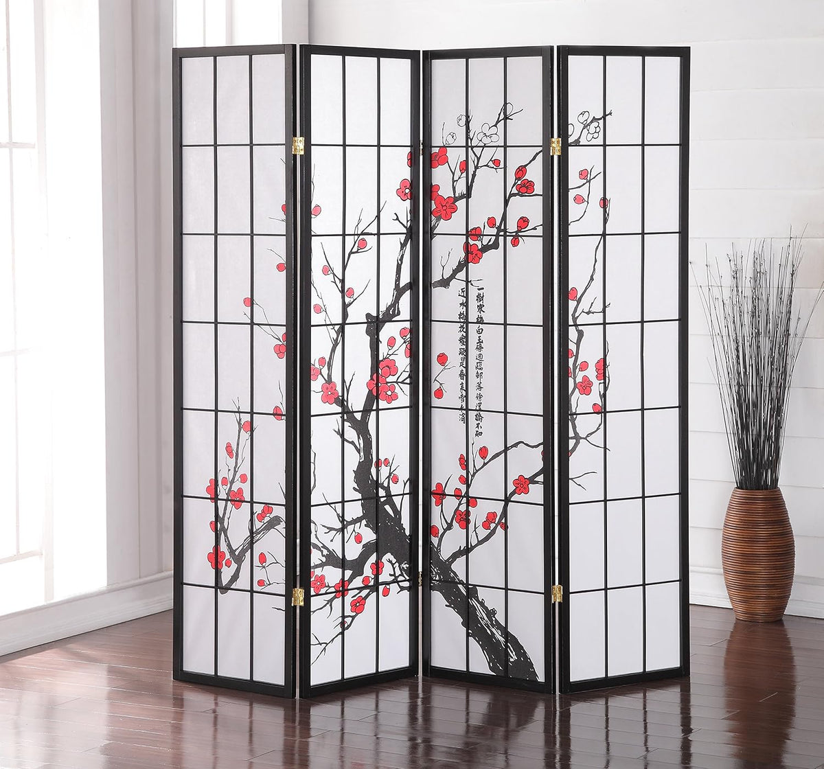 Room setting with black-framed screen on a rug near a window displaying the red blossom pattern across panels