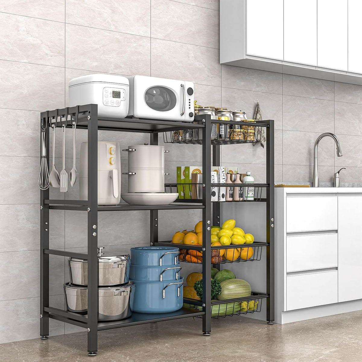 Black kitchen rack beside counter with microwave and air fryer on shelves and fruit in wire baskets.