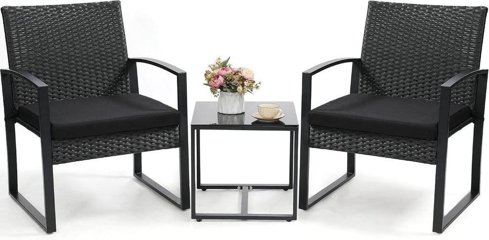 Three-piece set with two black rattan chairs and a square tempered glass table front view on white background