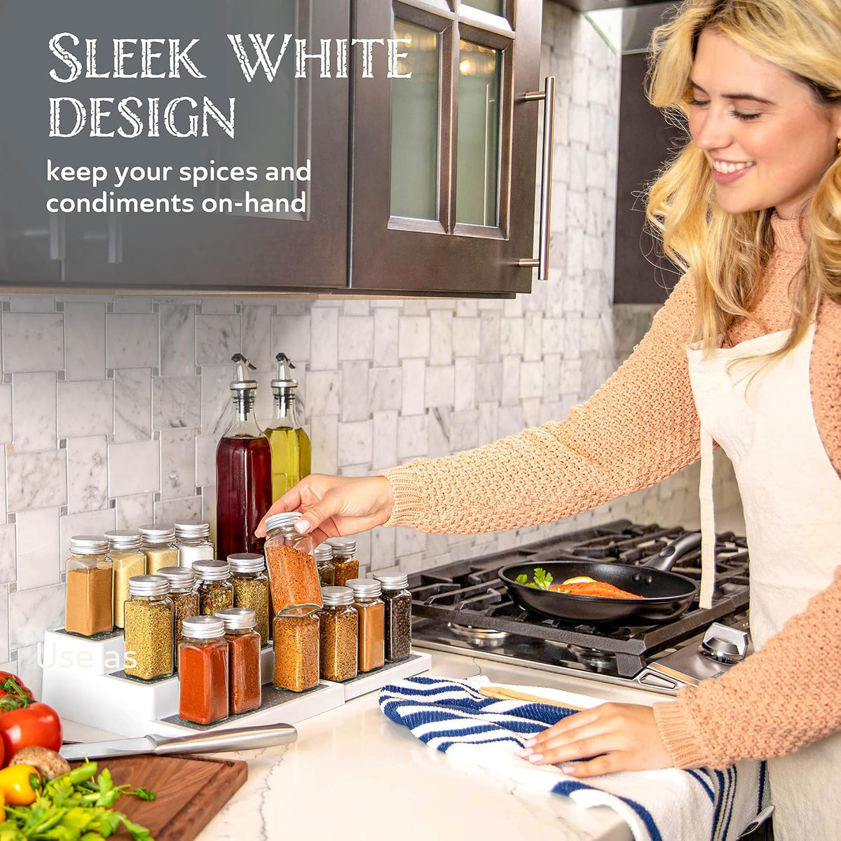 Person reaching for a spice jar from the white 3-tier rack next to a stovetop skillet