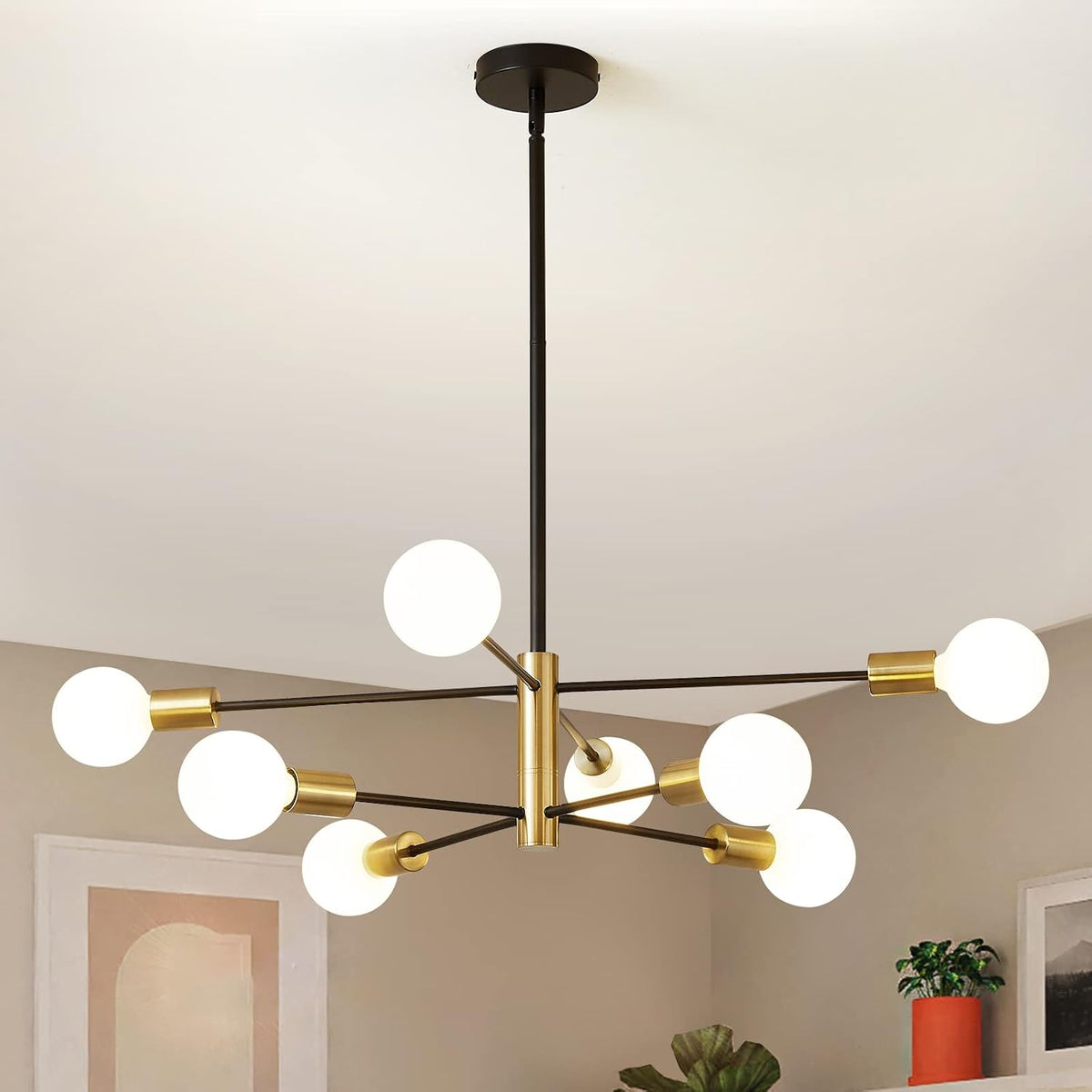 Ceiling sputnik chandelier with gold center and socket accents and white globe bulbs in a dining area.