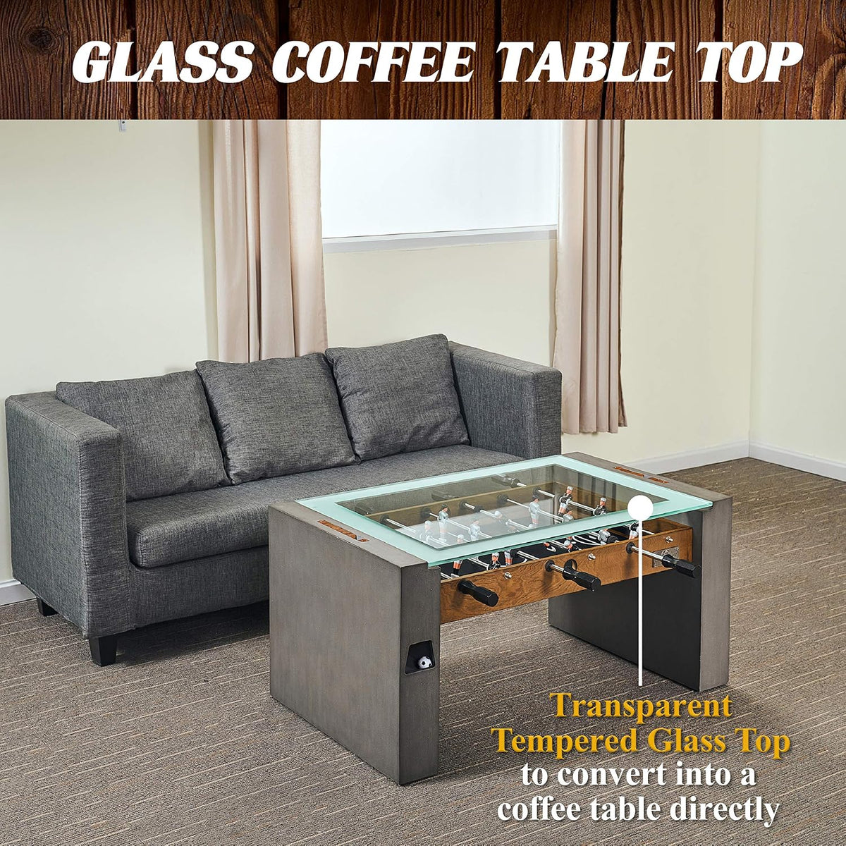 Foosball coffee table used as a glass-top coffee table in a living room beside a gray sofa