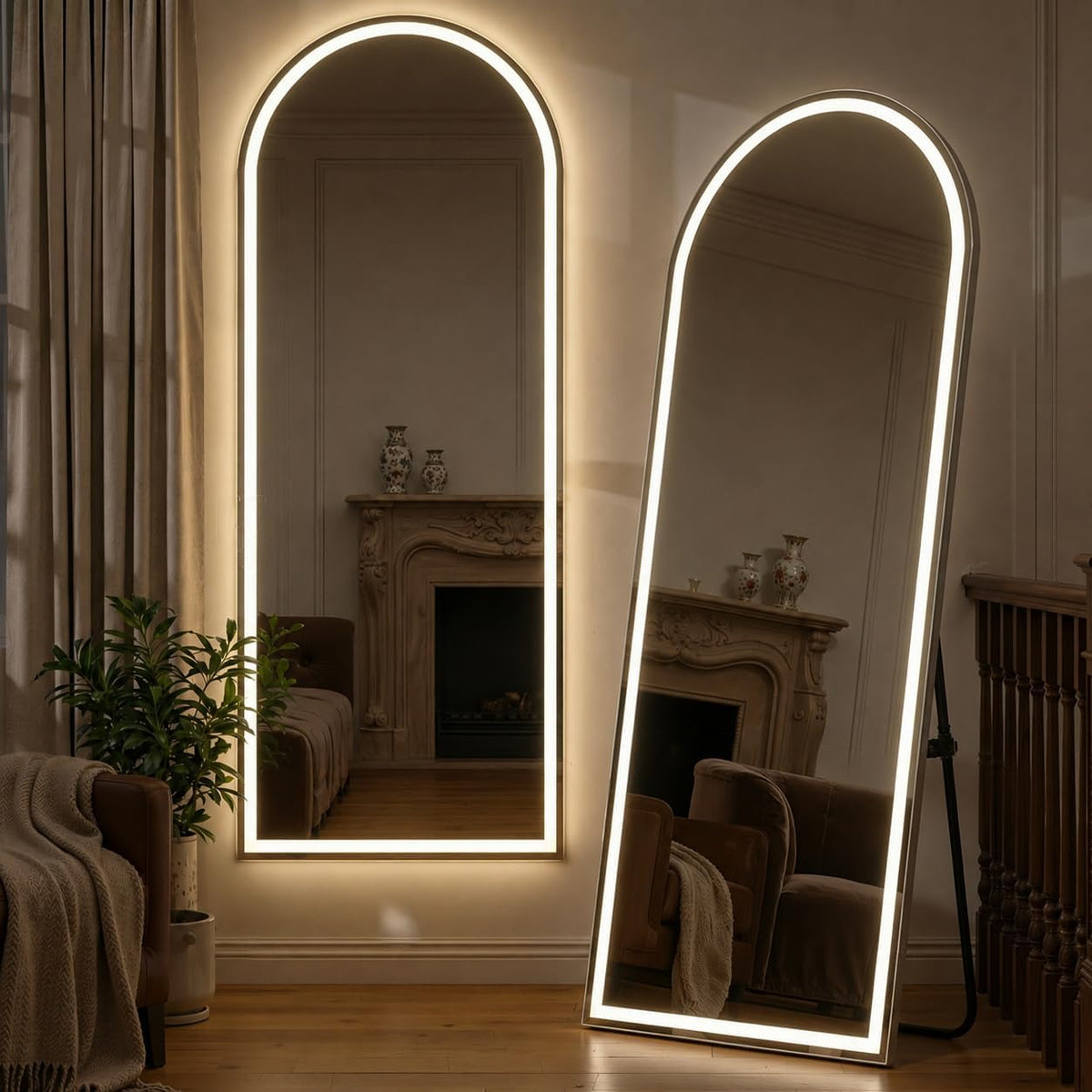 Arched wall mirror and leaning arched floor mirror with warm LED border in a living room setting