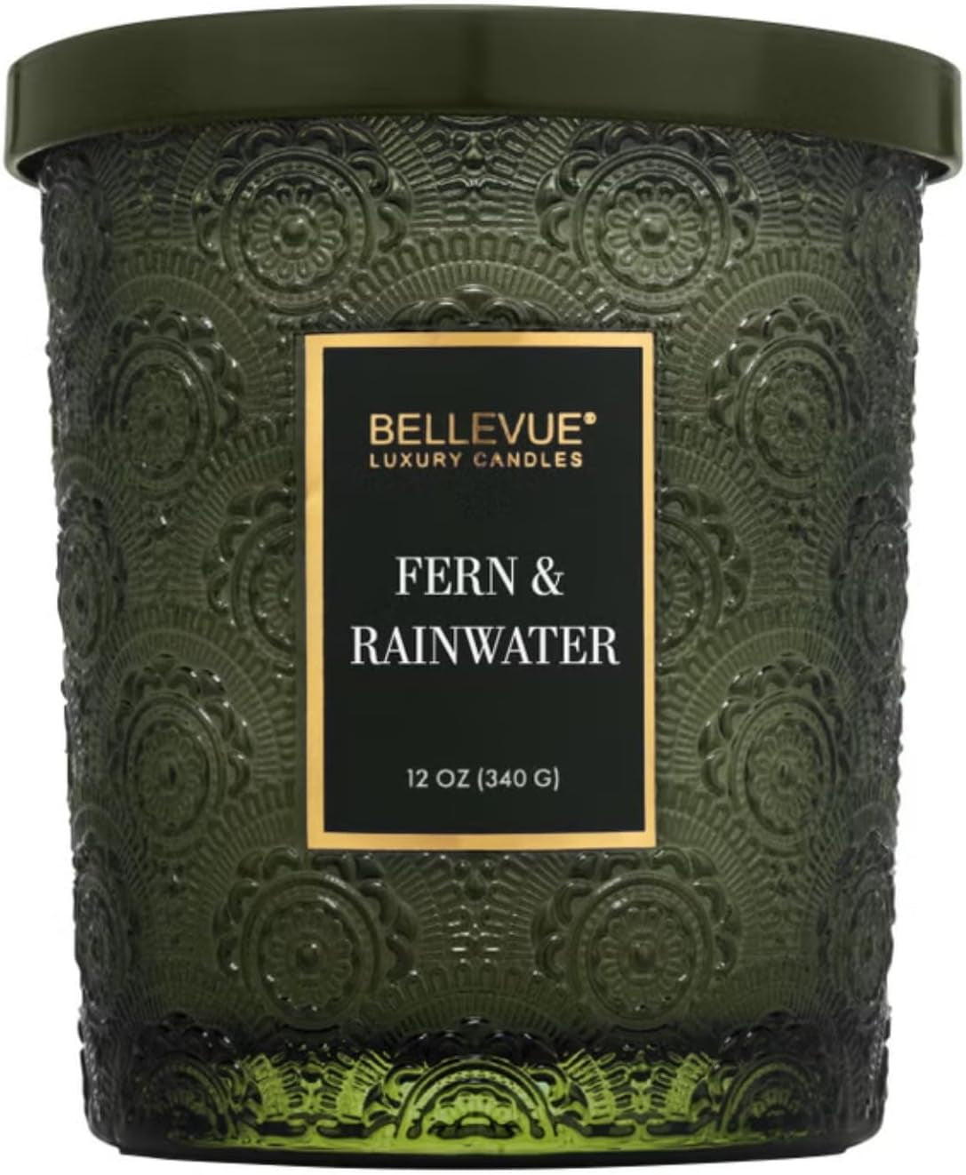 Close-up front view of a green embossed glass jar candle with green lid and centered label