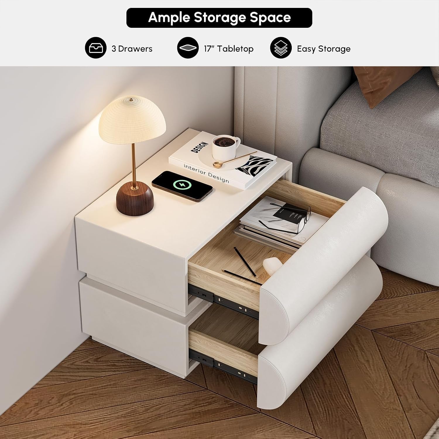 Angled view of a white nightstand beside a bed with both drawers open revealing wooden interiors and tabletop items.
