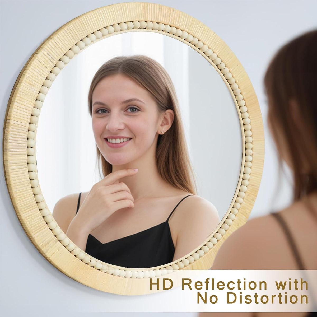 Round rattan mirror with bead trim reflecting a smiling woman at a close angle