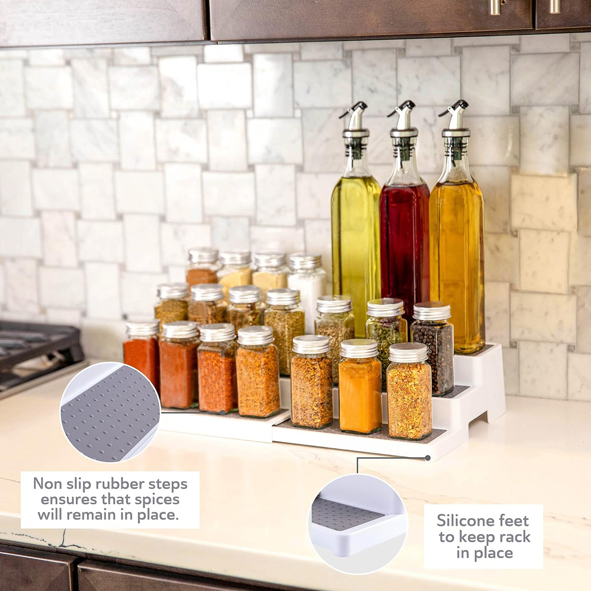 White 3-tier rack on a kitchen counter holding spice jars and three tall oil bottles, countertop view