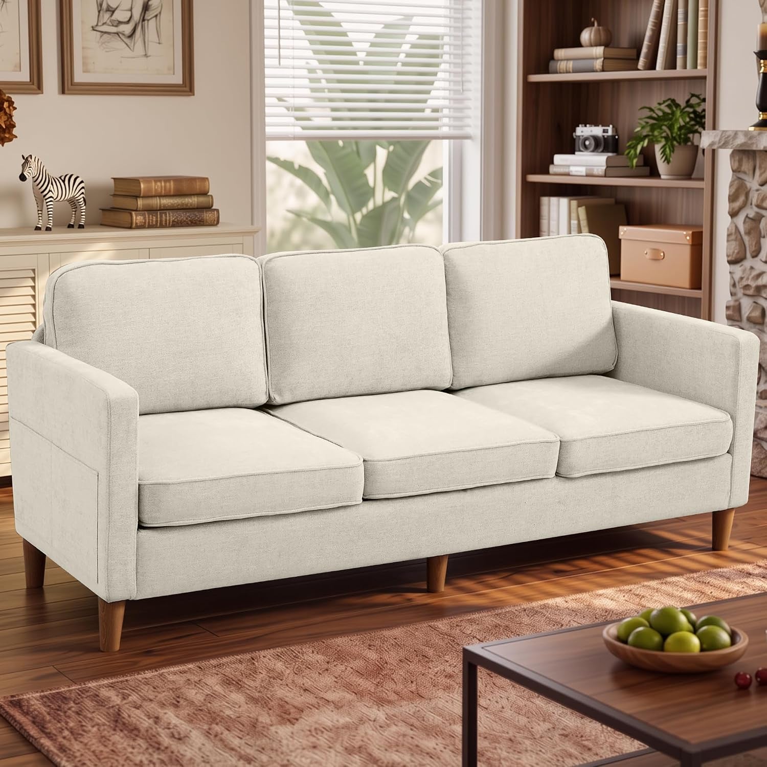 Light beige three-seat sofa with tapered wood legs in a cozy living room setting