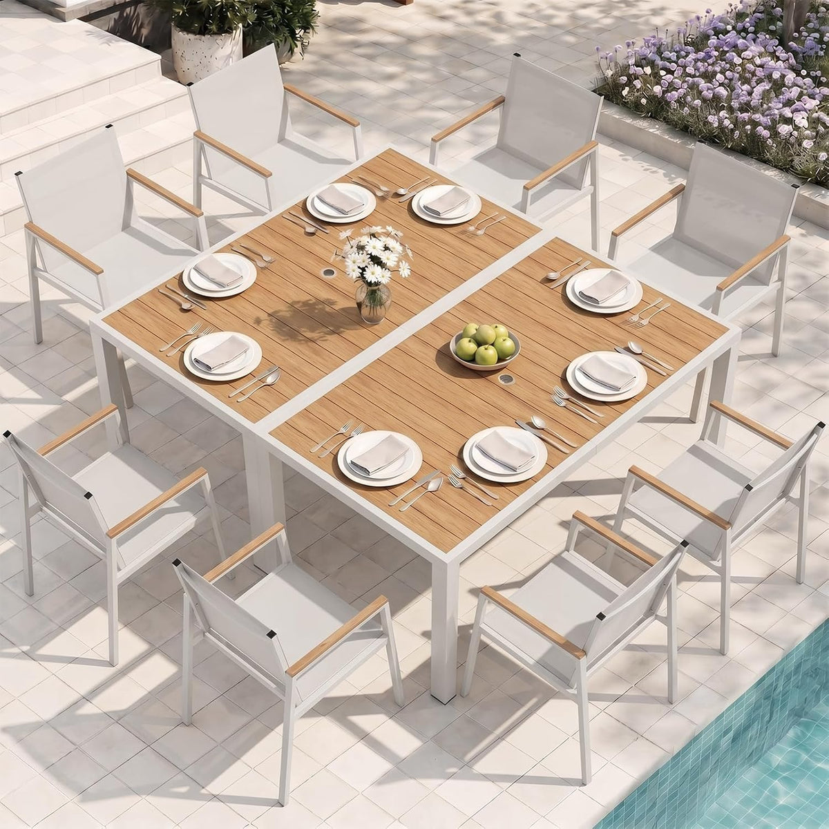 Aerial view of two square dining tables pushed together to form a larger rectangular setup with white chairs.