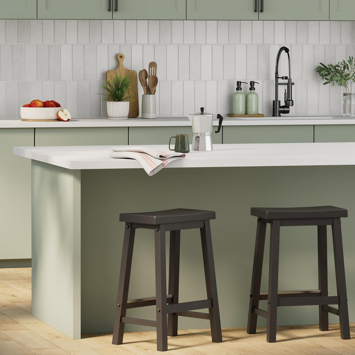 Two black solid wood 24-inch counter stools placed at a light-green kitchen island in a room setting