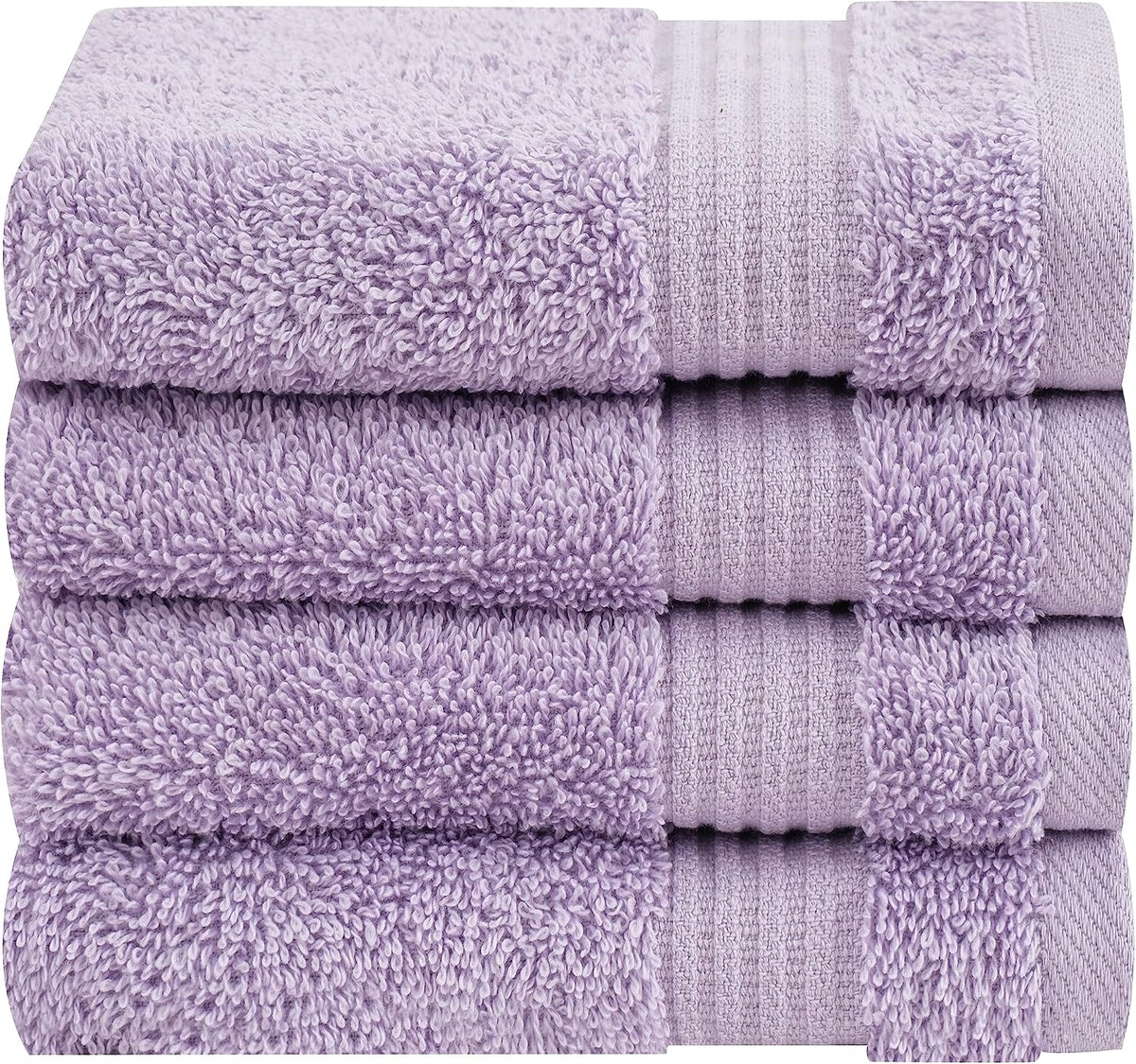 Close-up of a neat stack of four light purple terry towels showing looped pile and woven border.