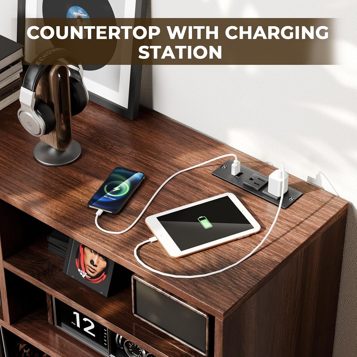 Top view of walnut tabletop showing built-in power strip with two outlets and two USB ports charging a phone and tablet