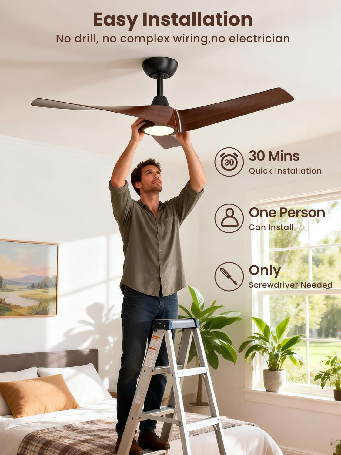 Man standing on a ladder installing a dark walnut three-blade fan, reaching up to the light assembly.