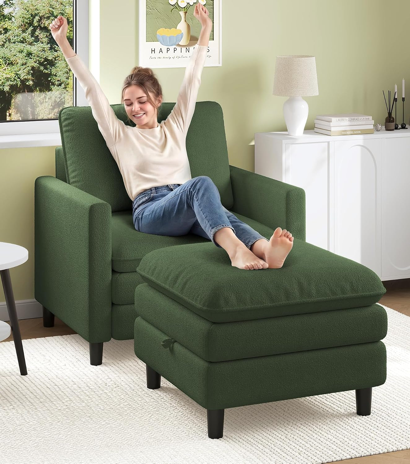 Woman stretching with feet on a matching dark green ottoman in front of a green loveseat