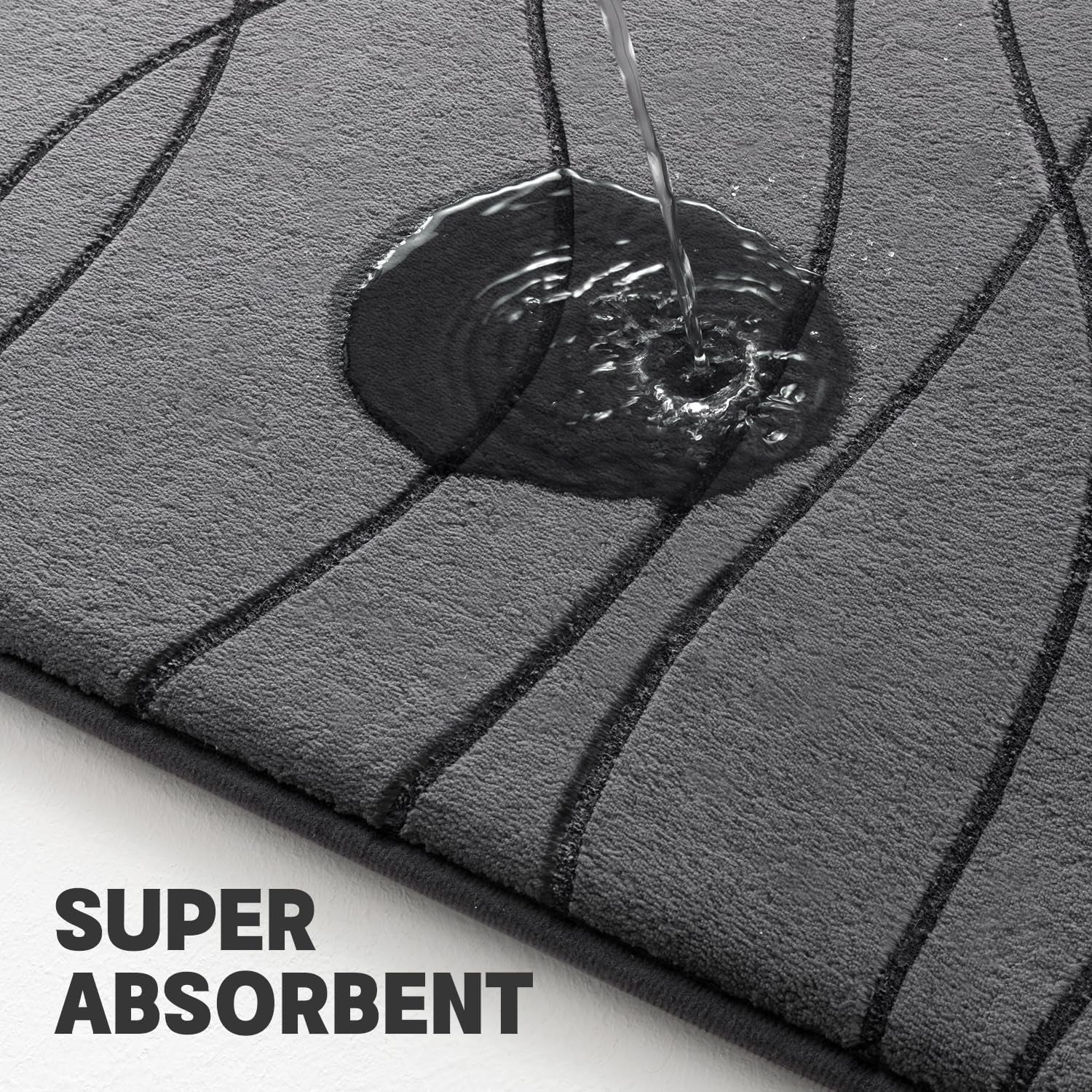 Close-up of dark grey rug surface with water being poured to demonstrate absorbency and textured wave pattern