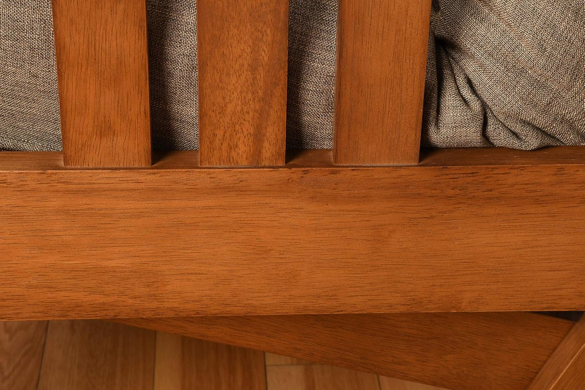Tight crop of the wooden lower rail and three vertical slats with a light textured cushion visible above.