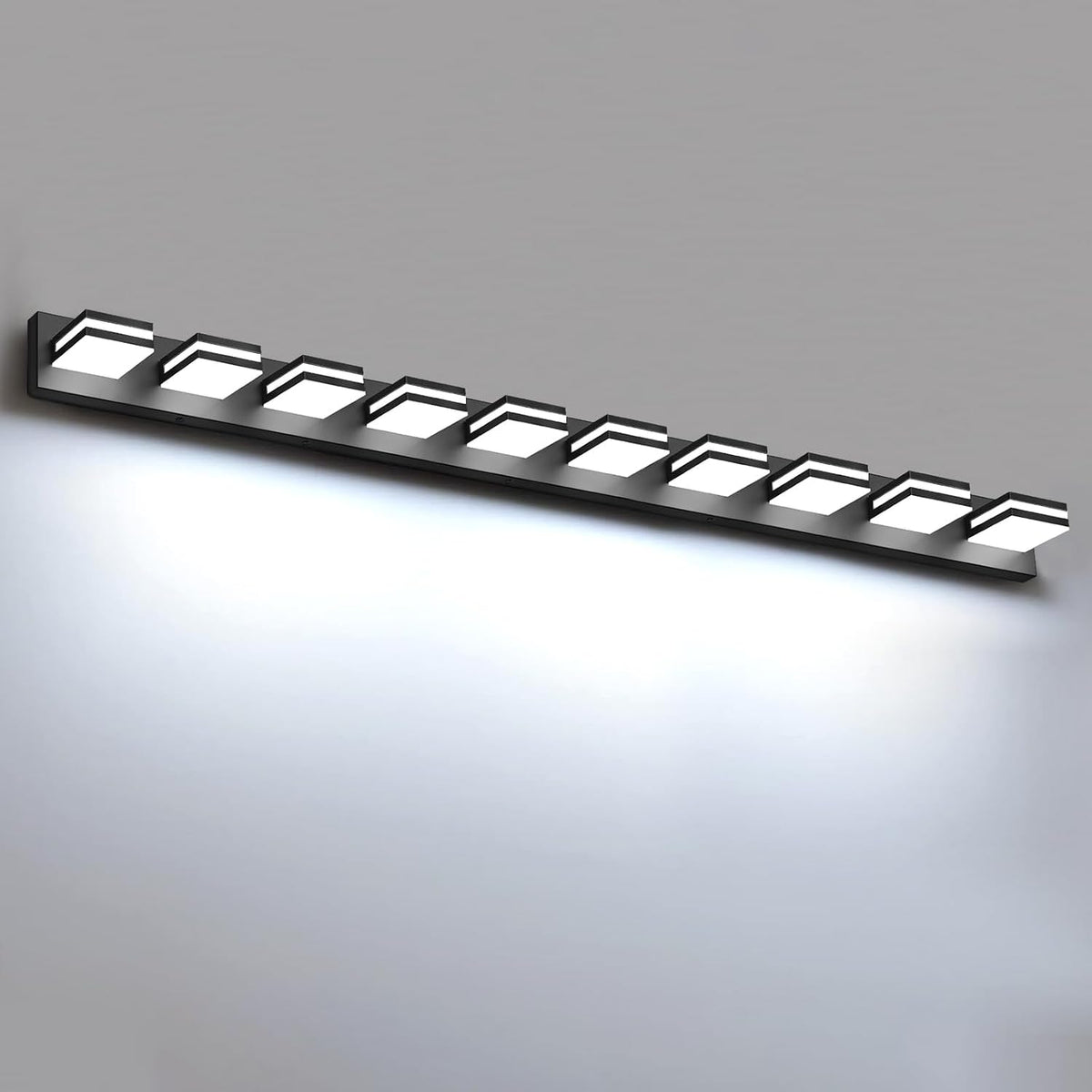 Slim black LED vanity bar with eight glowing square lights installed on a light gray wall.