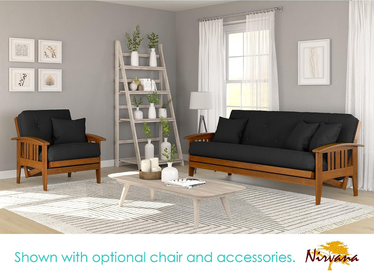 Living room scene with wood futon frame and matching armchair with black cushions on a light wood floor