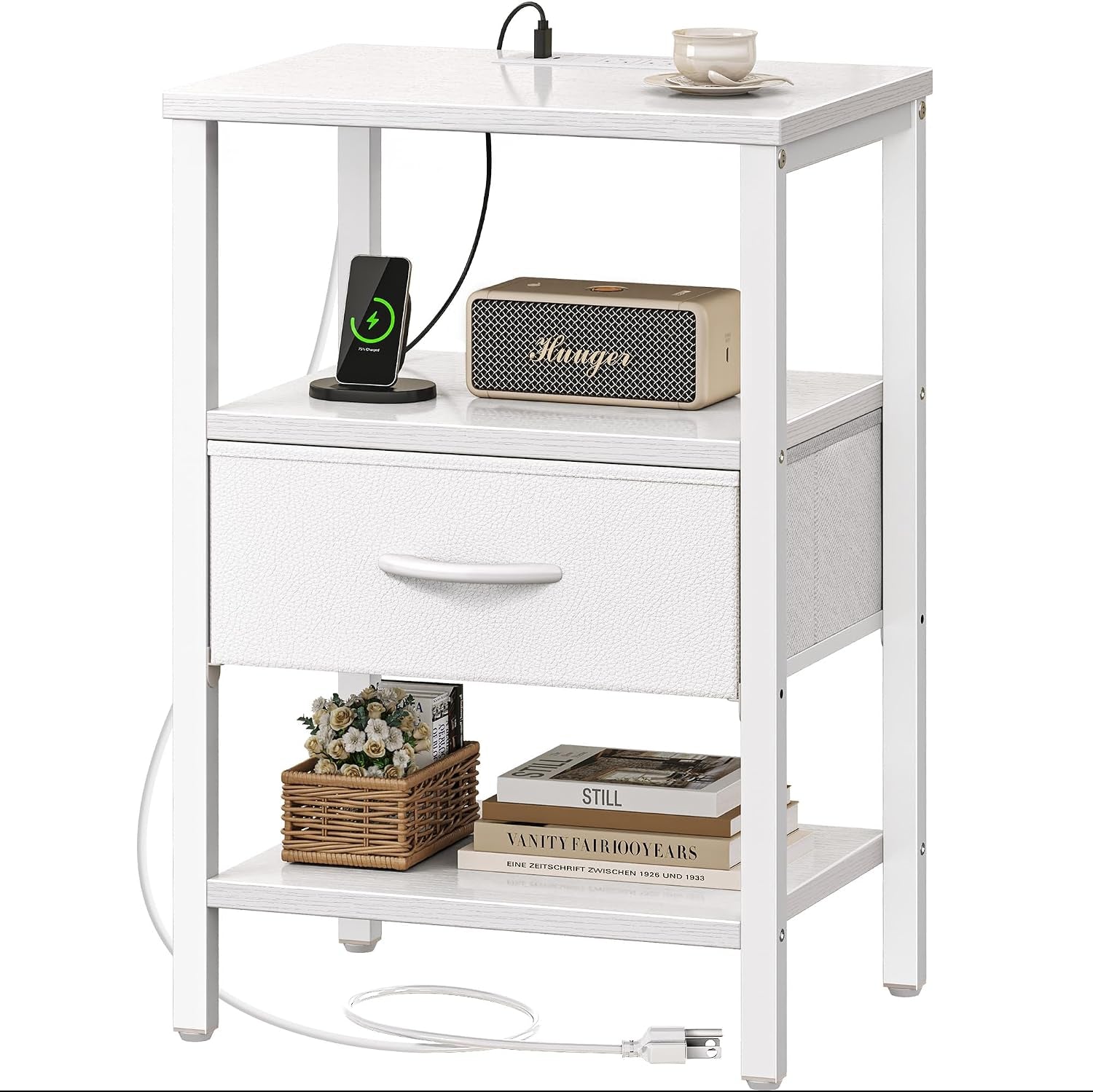 Three-tier white nightstand front view with charging cable and phone on top, fabric drawer, lower shelf with basket and
