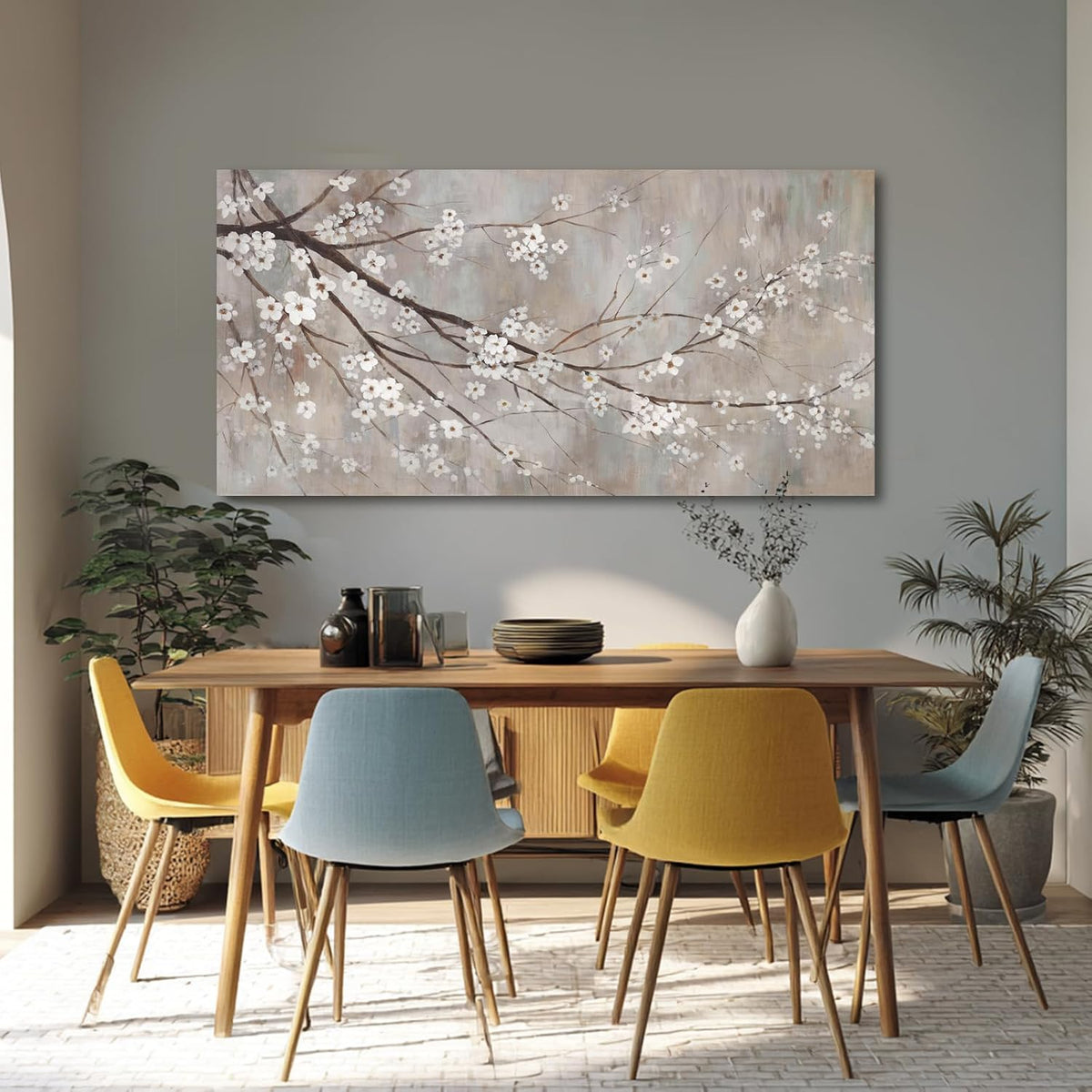 Plum blossom canvas hung above a dining table with colorful mid-century chairs.