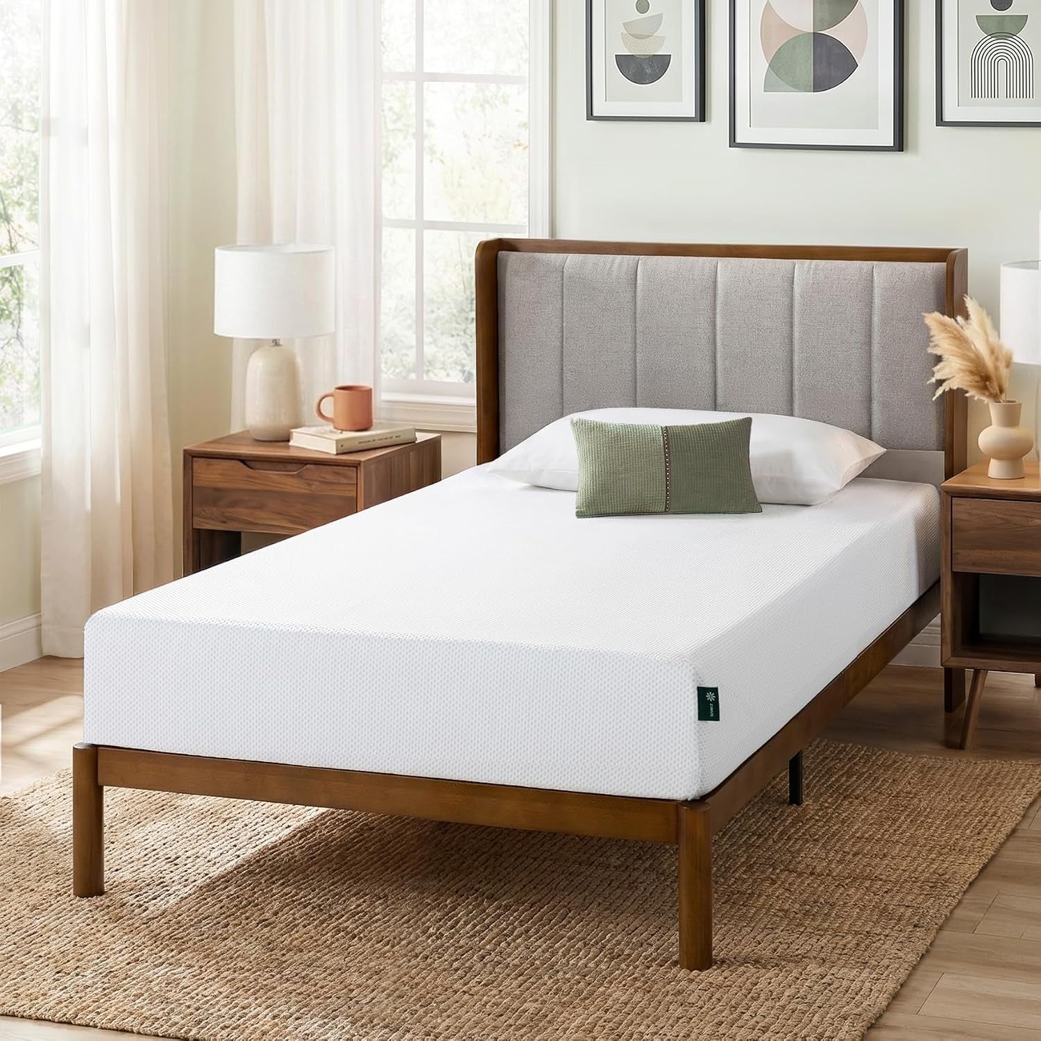 White mattress on a wooden bed with upholstered headboard in a sunlit bedroom with nightstands