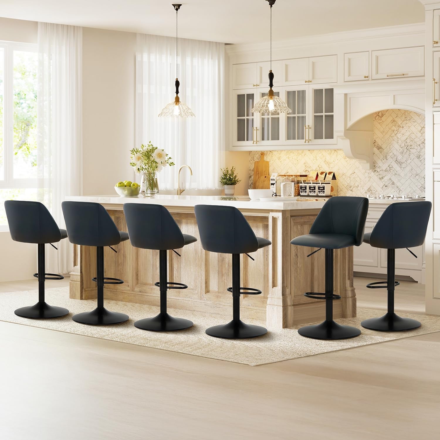 Wide kitchen scene with six dark charcoal swivel bar stools lined at a light wood island