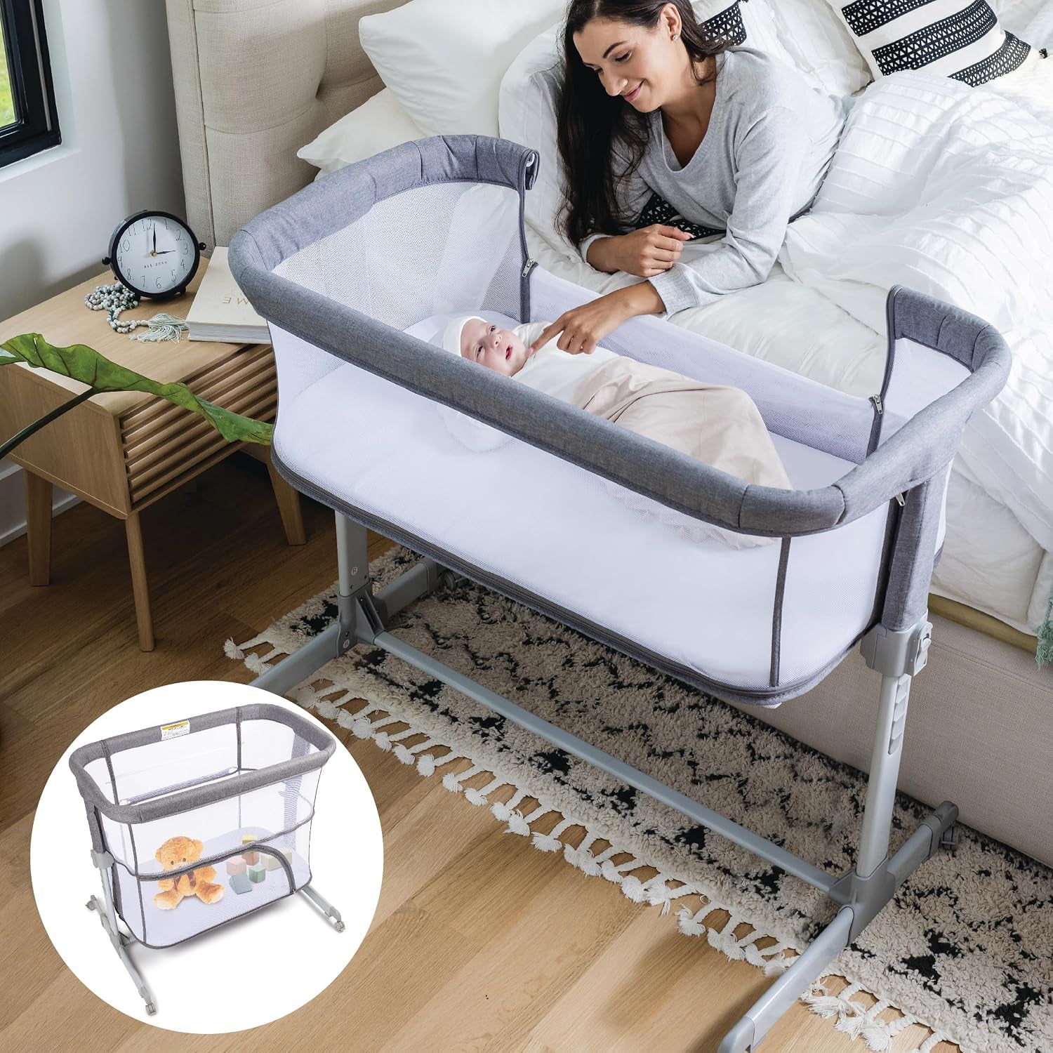 Gray bedside crib beside a bed with a mother smiling at her baby; inset shows crib storage view