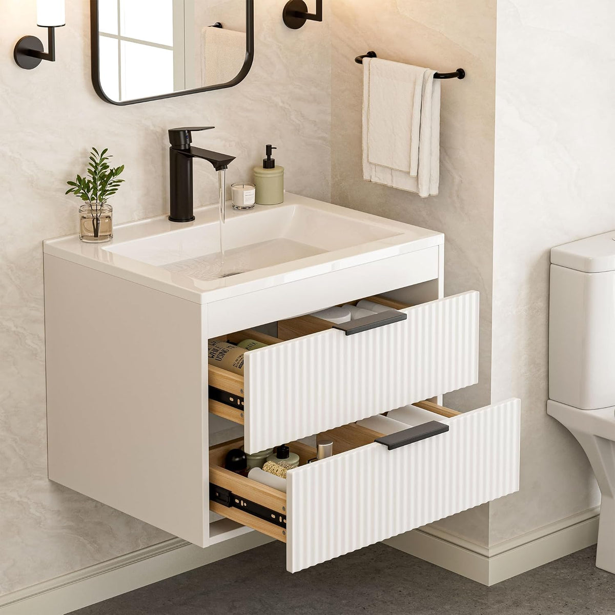 Angled view of a wall-mounted white vanity with white sink, black faucet and two ribbed drawers pulled open.