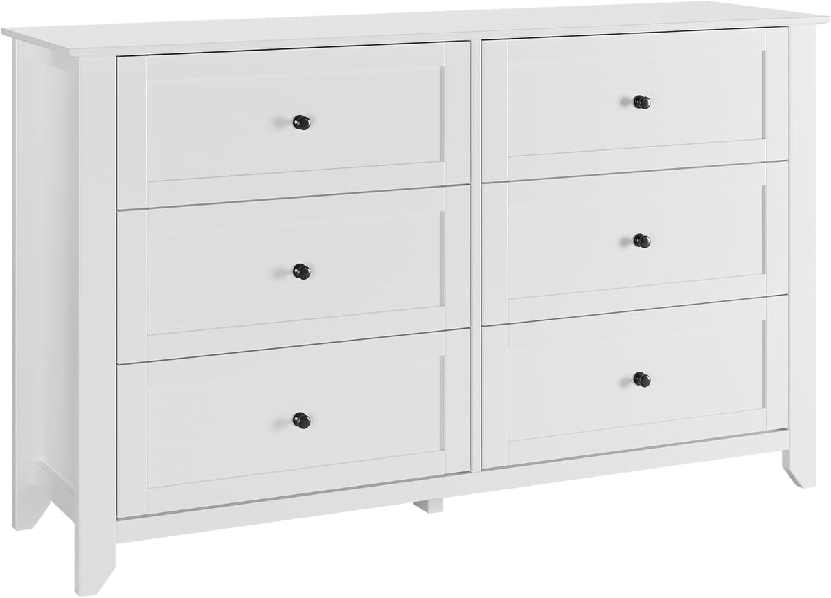 Studio front view of white six-drawer dresser showing black round knobs