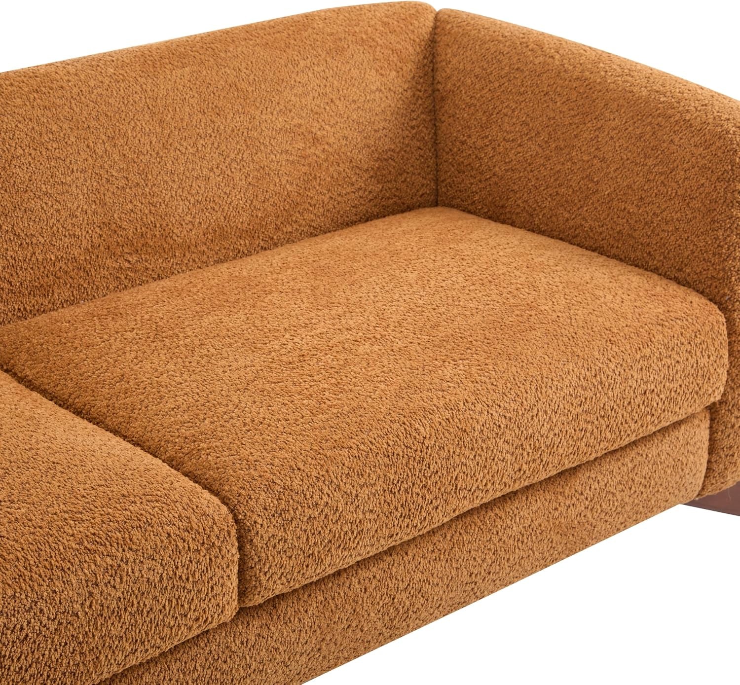 Close-up of caramel faux sherpa upholstery showing nubby textured surface on seat cushion and arm