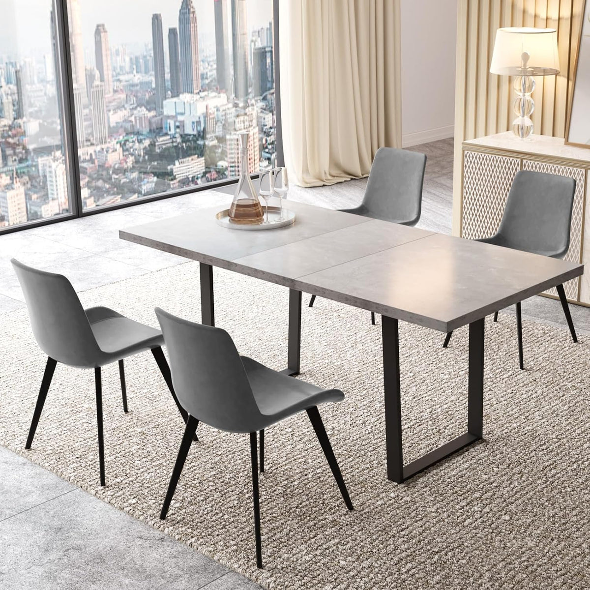 Rectangular grey tabletop with four grey PU chairs and black metal legs in a bright corner room.