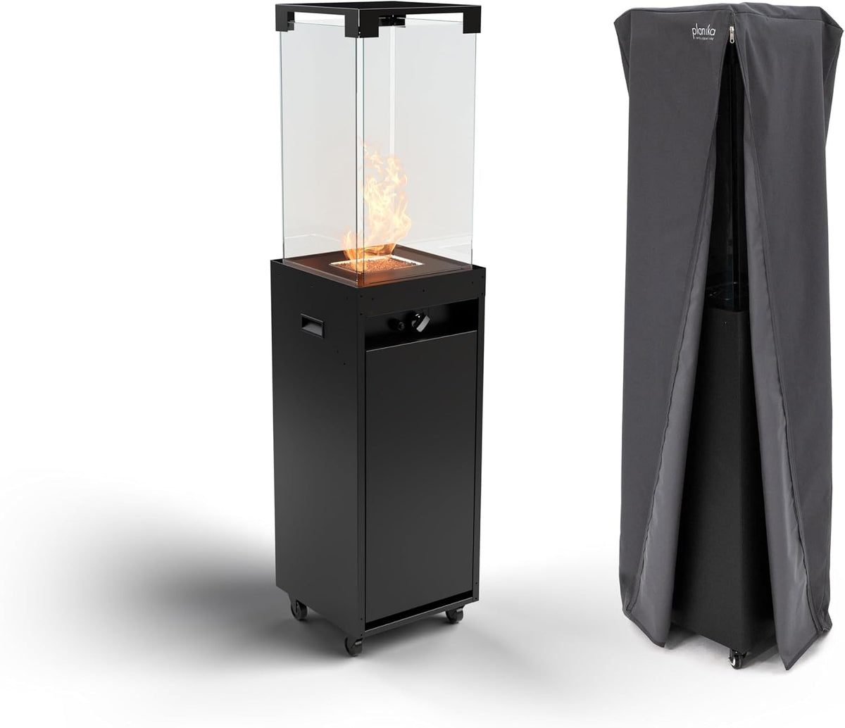 Tall black freestanding glass-topped patio heater on casters shown next to its gray protective cover.