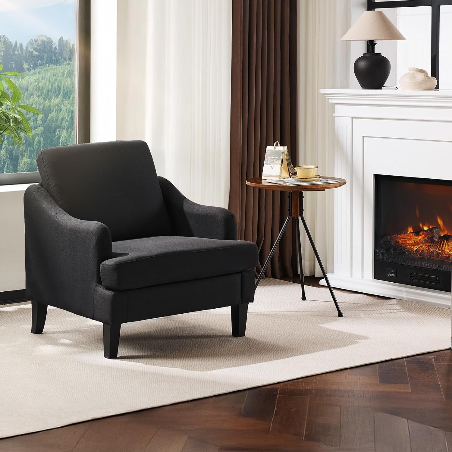 Single dark charcoal armchair in a living room by a white mantel and round side table
