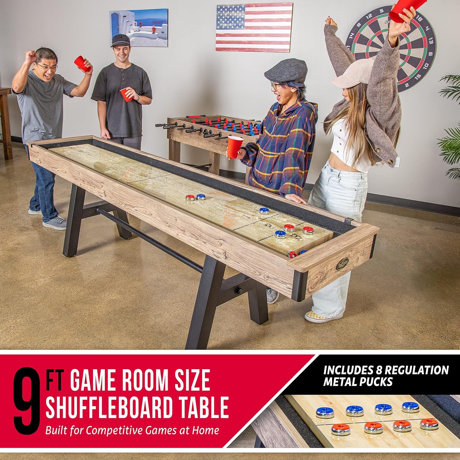 9 ft shuffleboard table in a game room setting with four players celebrating and a foosball table visible in the background