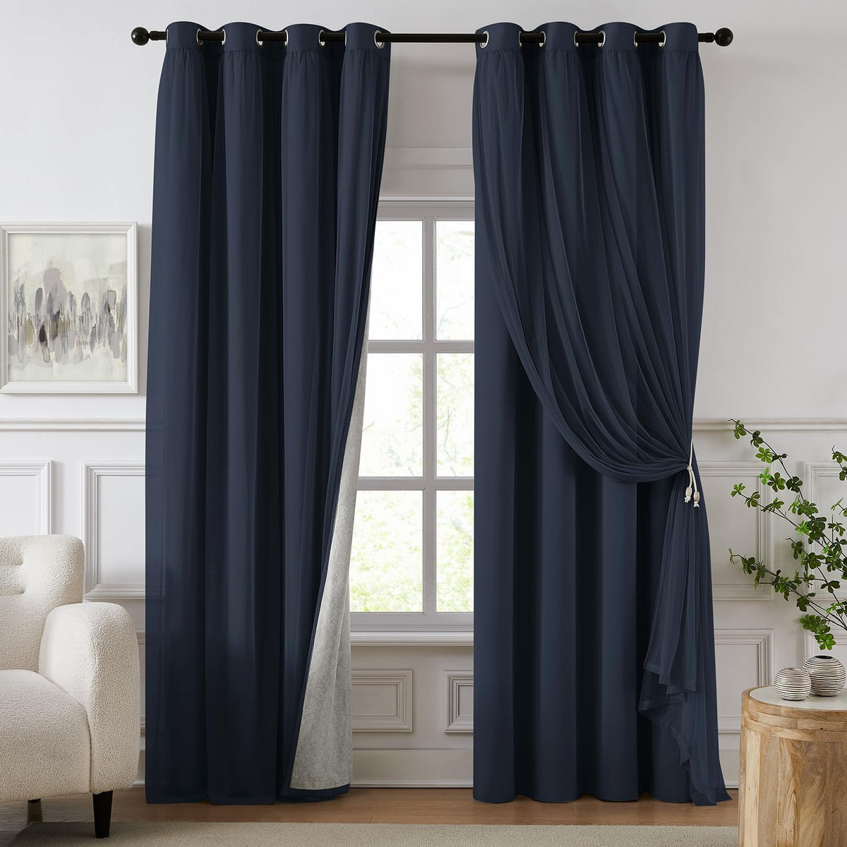 Window dressed with deep navy blackout panels and matching sheer overlay tied to the right