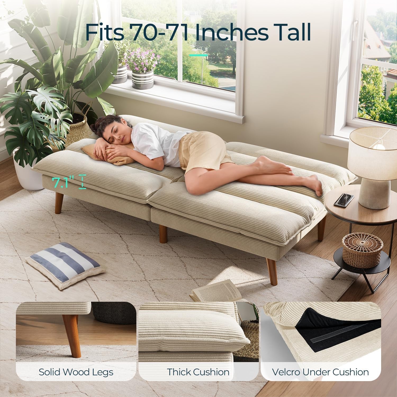 Beige corduroy futon laid flat as a bed with a woman sleeping on it in a bright windowed room.