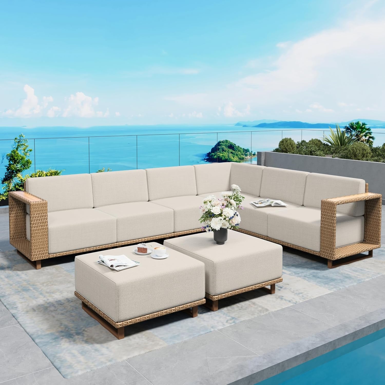Beige rattan modular outdoor sectional with two matching ottomans, angled front view beside a pool